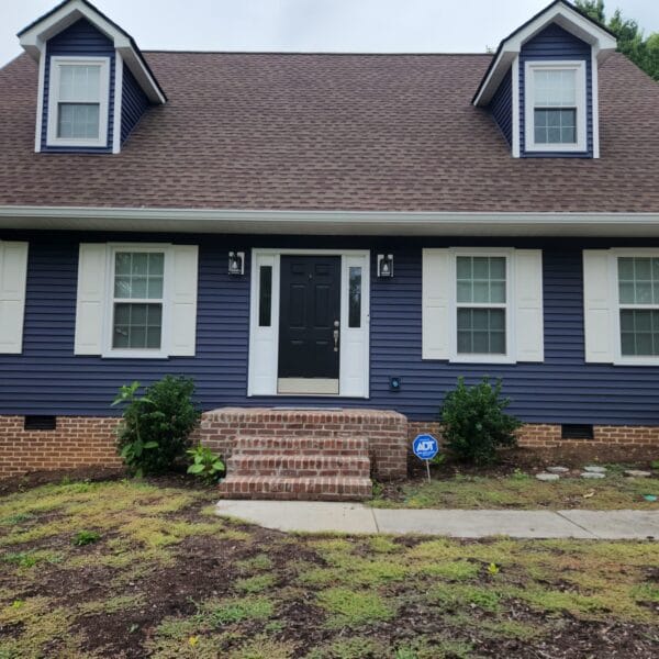 Navy blue Cape Cod home with new lap siding, white shutters and brick steps in Knoxville, TN