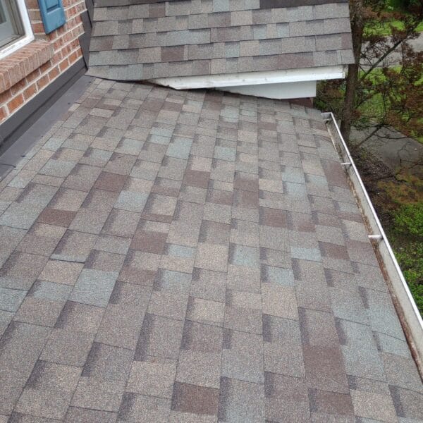 Roof repair over porch with damaged asphalt shingles in Knoxville TN