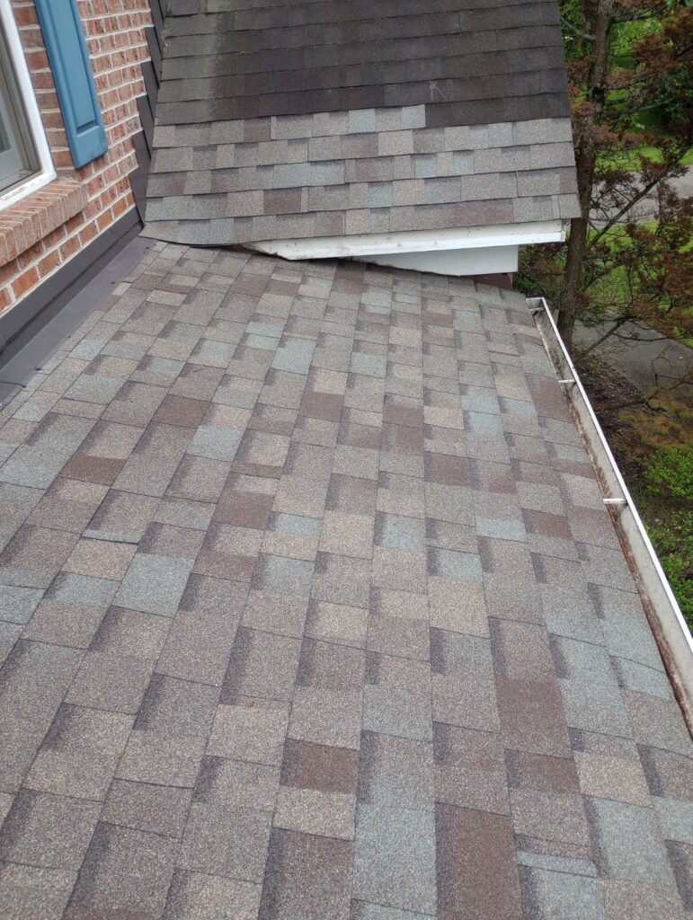 Roof repair over porch with damaged asphalt shingles in Knoxville TN