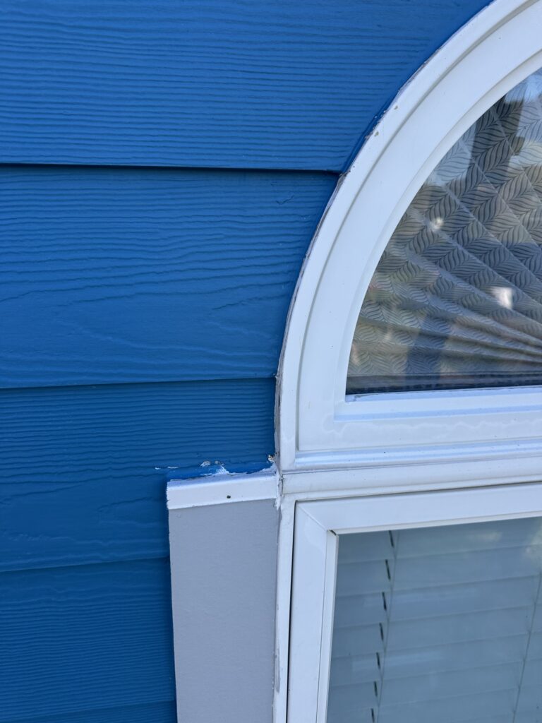 Premium blue vinyl siding installation with custom window trim in Knoxville