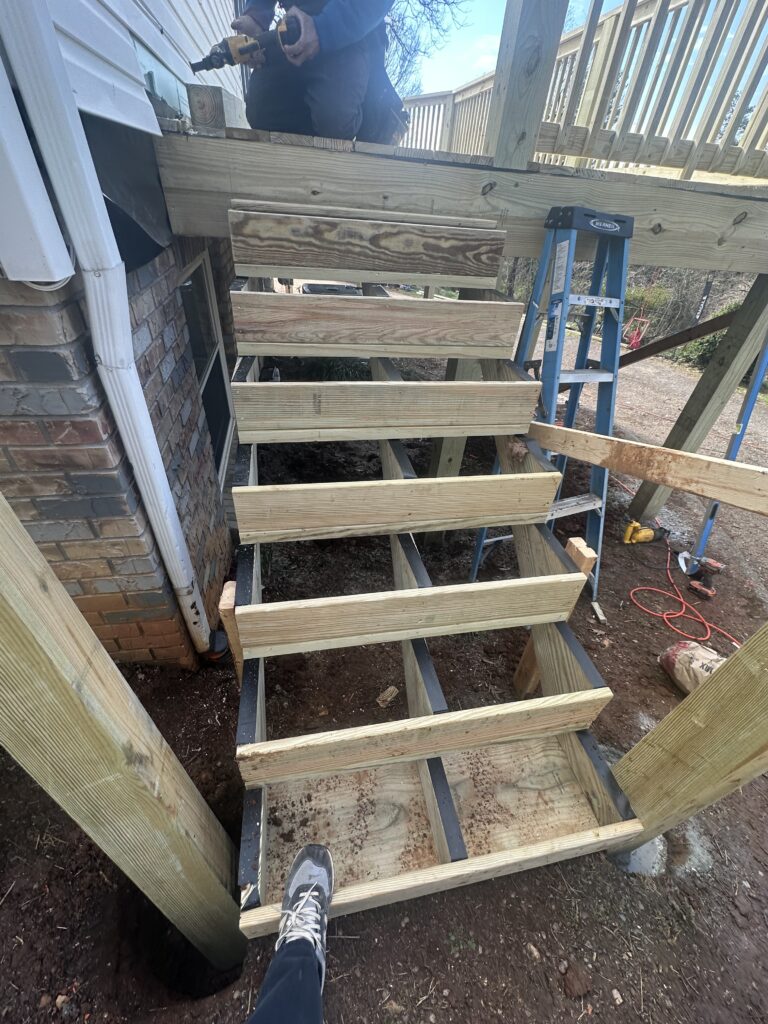 Example of a poorly attached deck ledger board causing structural failure.