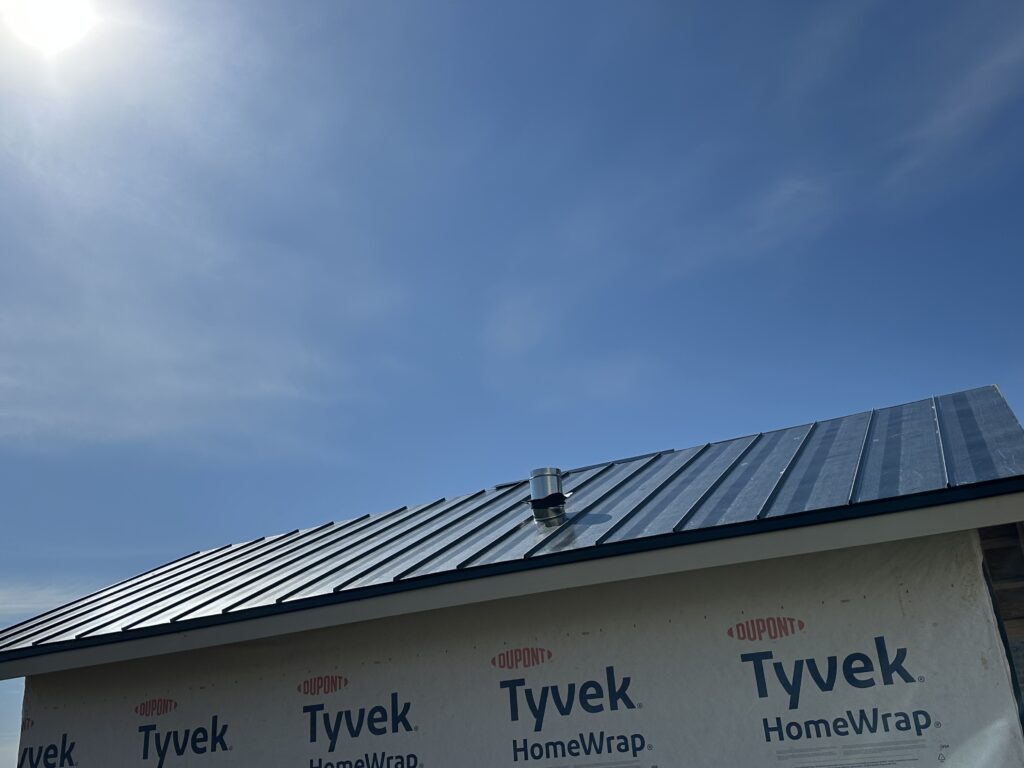 Identifying a roof leak around a plumbing vent pipe during a technical inspection.