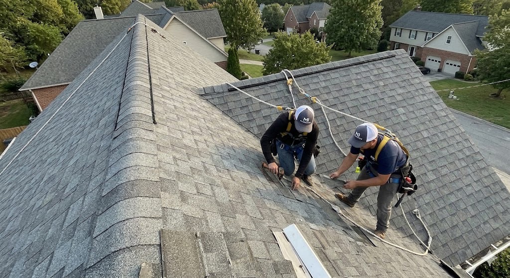 Dramatic side shot of a steep pitch residential roof requiring harnesses and safety ropes for a roof replacement project in Knoxville TN.