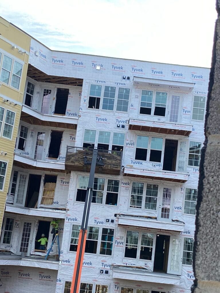 Removing old window sealant to ensure a clean surface for new high-performance caulk