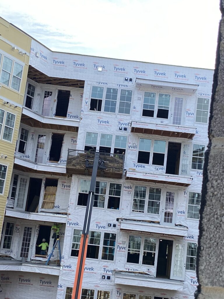 Removing old window sealant to ensure a clean surface for new high-performance caulk