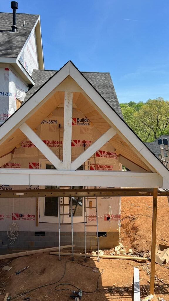 Dark water stains and mildew growth on a wooden deck surface.