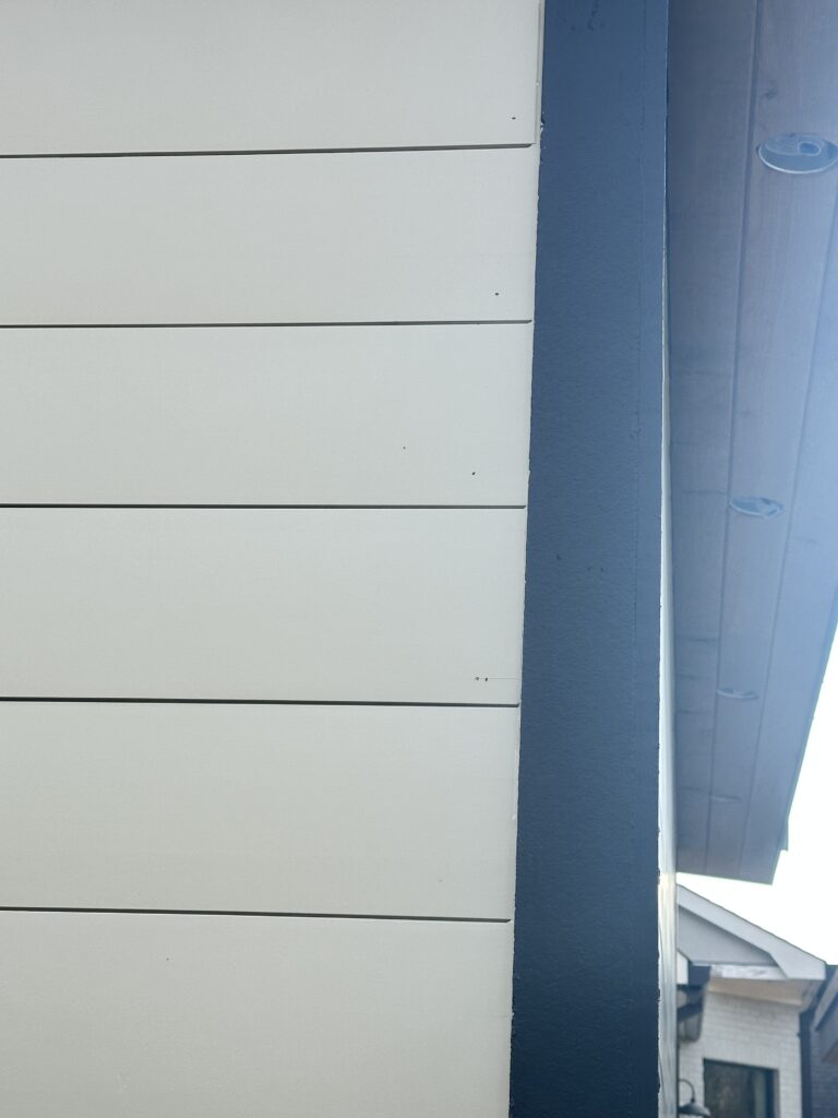 Sustainable rice hull siding by ACRE installed in a shiplap profile, featuring a flawless nickel gap finish.