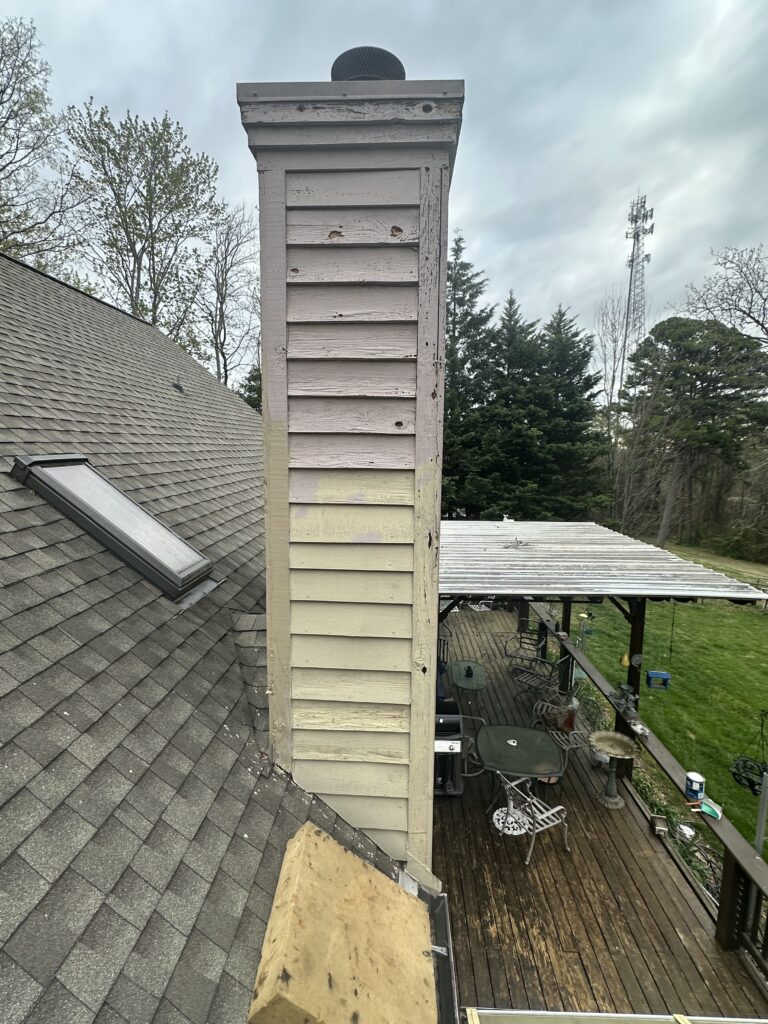 Rear exterior of a Knoxville home under massive attack by three different woodpecker species (Pileated, Hairy, and Downy), causing extensive damage to cedar shingles.