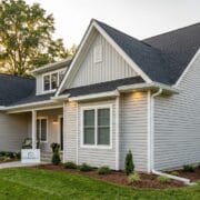 Stunning full front view of a premium Knoxville home at golden hour featuring new seamless gutters installed by MI Homesiding LLC.