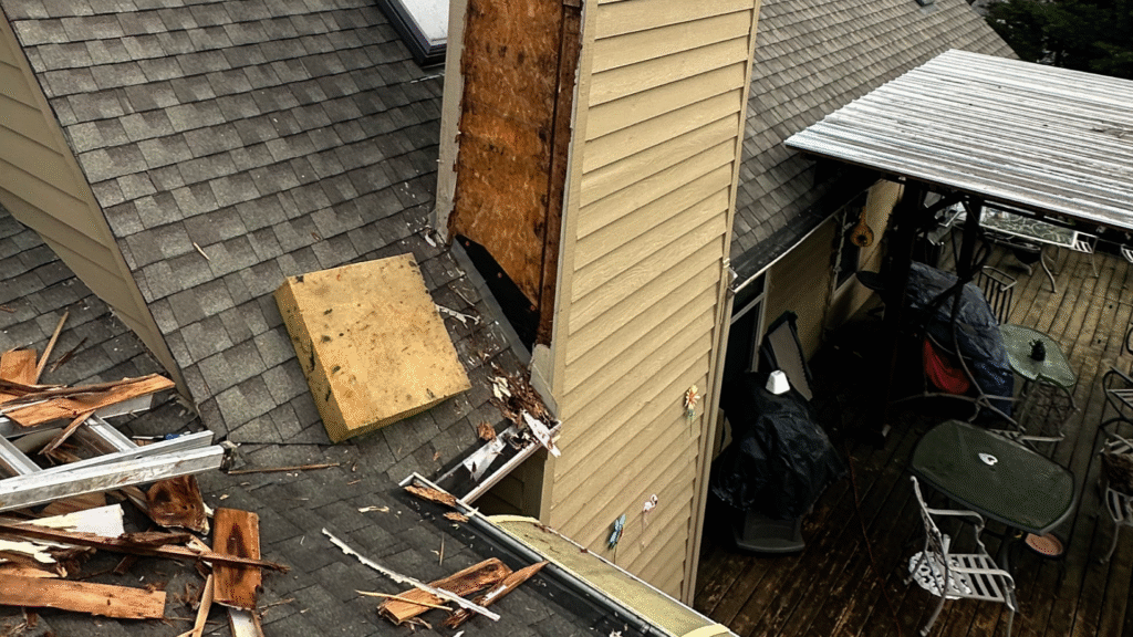 MI Homesiding expert installing critical kickout flashing on a roof-to-siding transition to prevent water leaks.