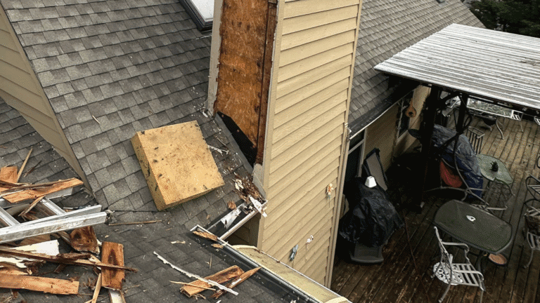 MI Homesiding expert installing critical kickout flashing on a roof-to-siding transition to prevent water leaks.
