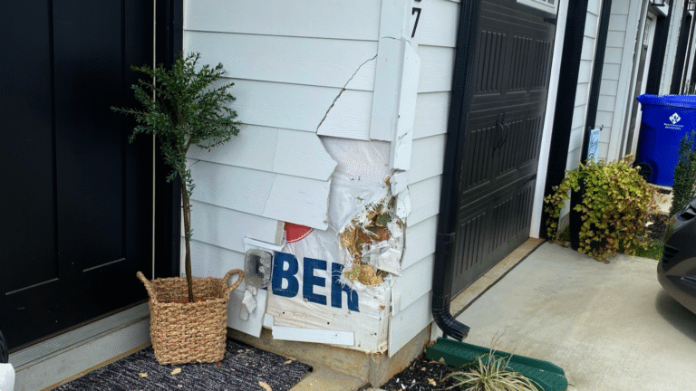 MI Homesiding LLC technician inspecting and re-securing loose siding fasteners using professional tools.