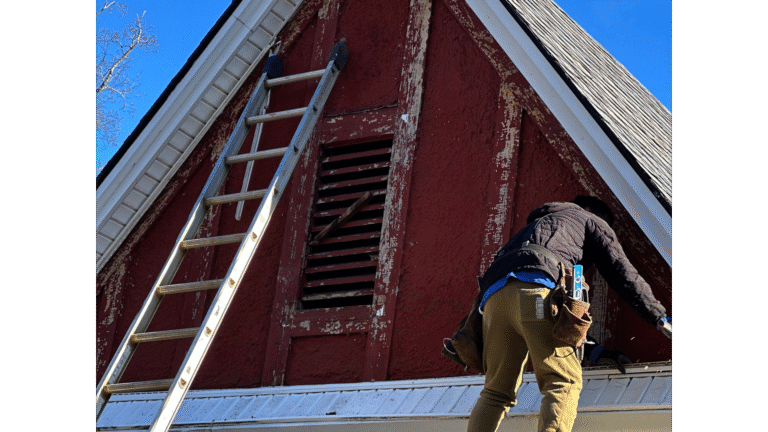 MI Homesiding LLC expert inspecting hidden water damage and moisture trapped behind vinyl siding.