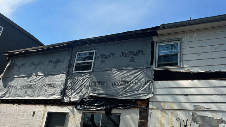 Visible gaps and loose vinyl siding panels caused by incorrect fastening techniques.