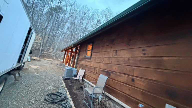Modern mountain home in Knoxville, TN seamlessly combining white LP SmartSide lap siding, dark walnut TruLog steel log siding, and black Board and Batten accents for a custom look by MI Homesiding LLC.