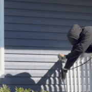 Prepping chalky aluminum siding for a fresh coat of paint.