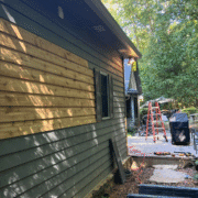Wood siding rotting at the bottom due to soil contact and moisture.