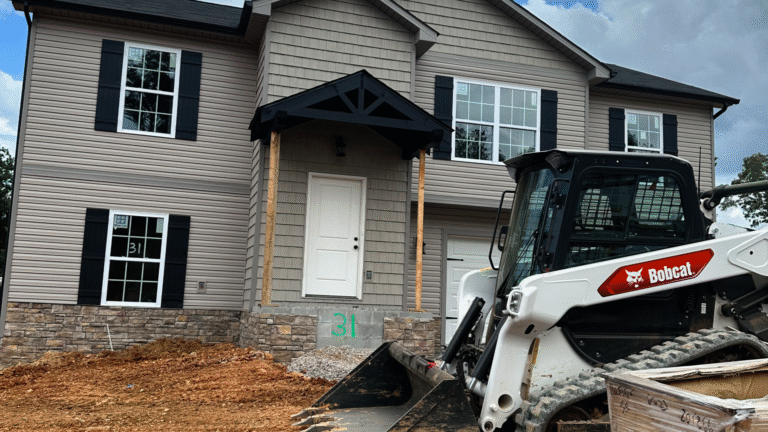 Siding installation on a 2-story new build with complex elevations.
