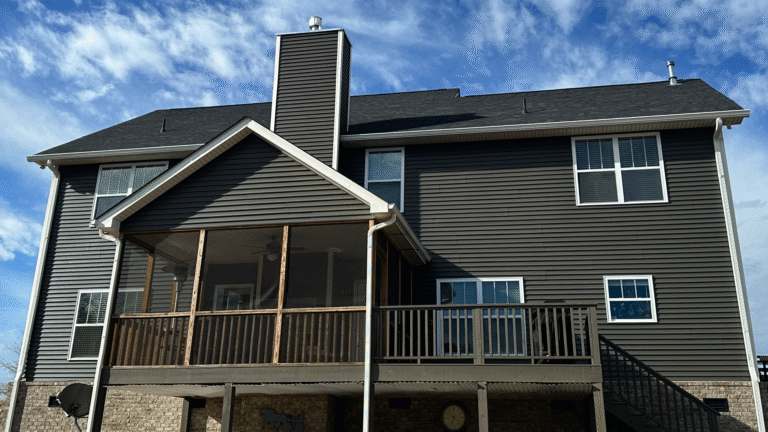 Contractor analyzing the cost difference between vinyl and Hardie board siding estimates