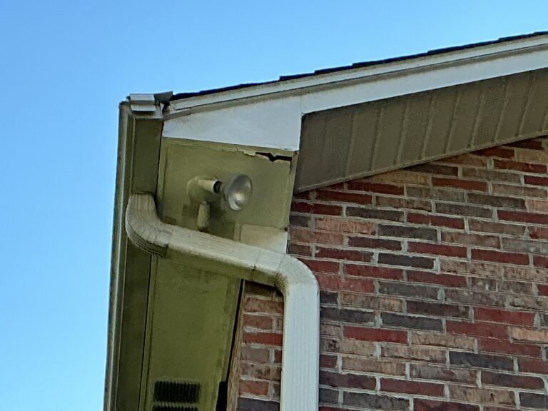 A close-up technical photograph detailing a new, clean white seamless gutter section with MI Homesiding LLC's high-strength hidden internal hangers installed at precise intervals and securely fastened through the new fascia wrap on a Knoxville home.