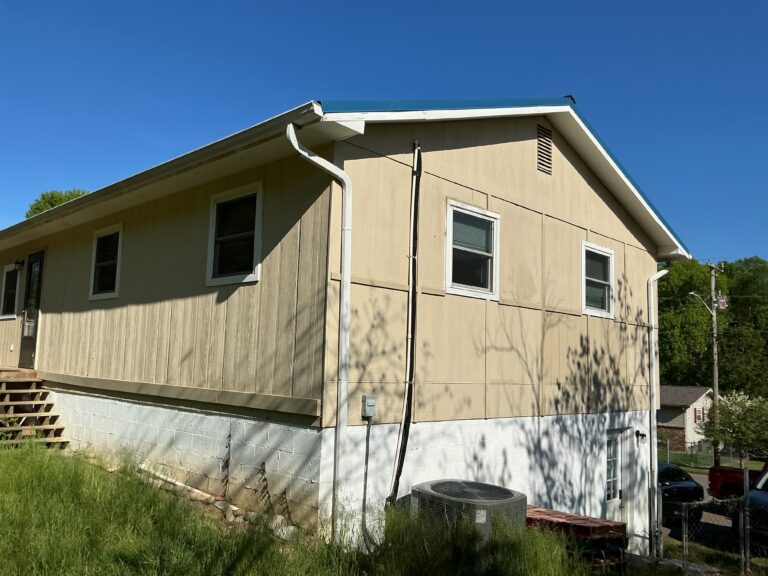 A technical documentary photograph showing a severely rotted and compromised main structural fascia board revealed near a corner valley on a Knoxville home during sag repair inspection, proving hidden decay must be corrected by MI Homesiding L