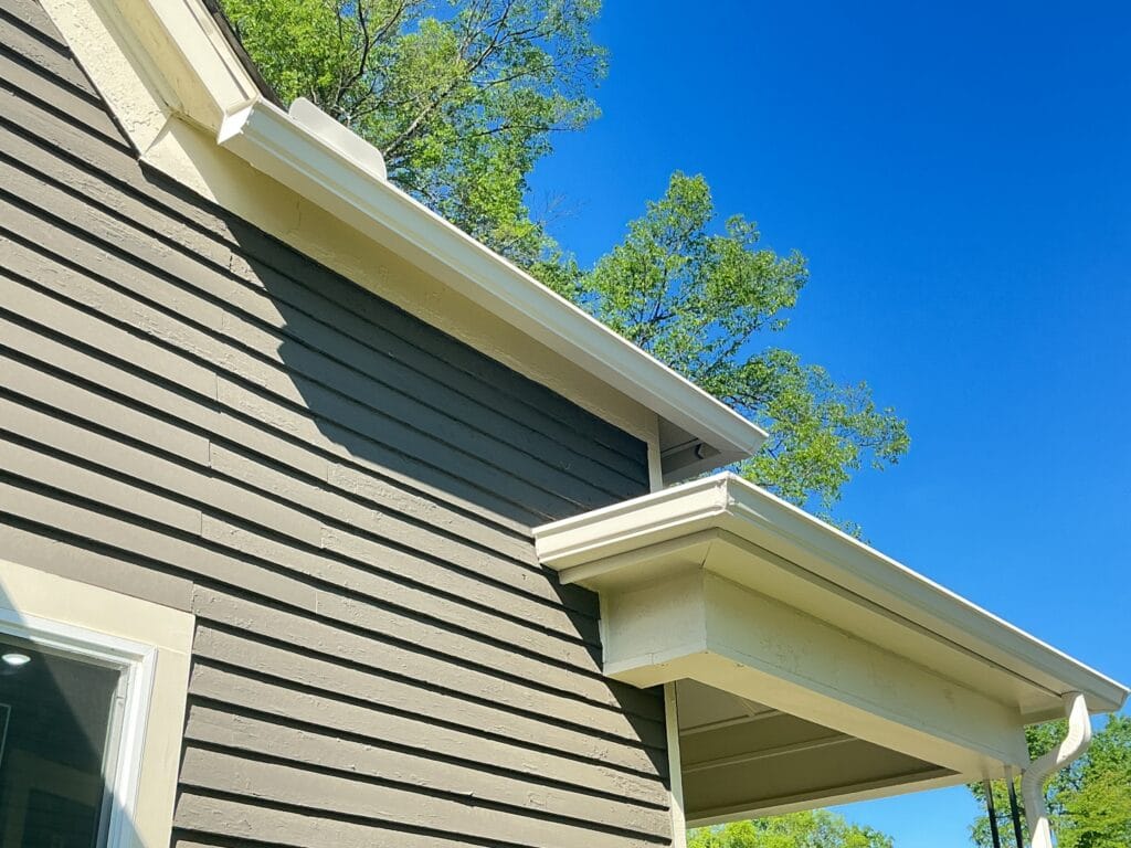 White gutter along the eave of a tan lap siding home in Knoxville, TN