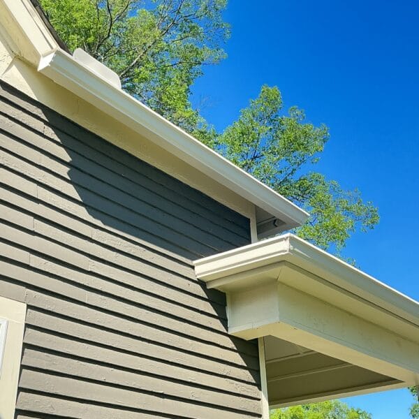 White gutter along the eave of a tan lap siding home in Knoxville, TN
