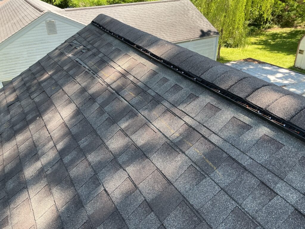Completed architectural shingle roof with the ridge vent running under the ridge cap