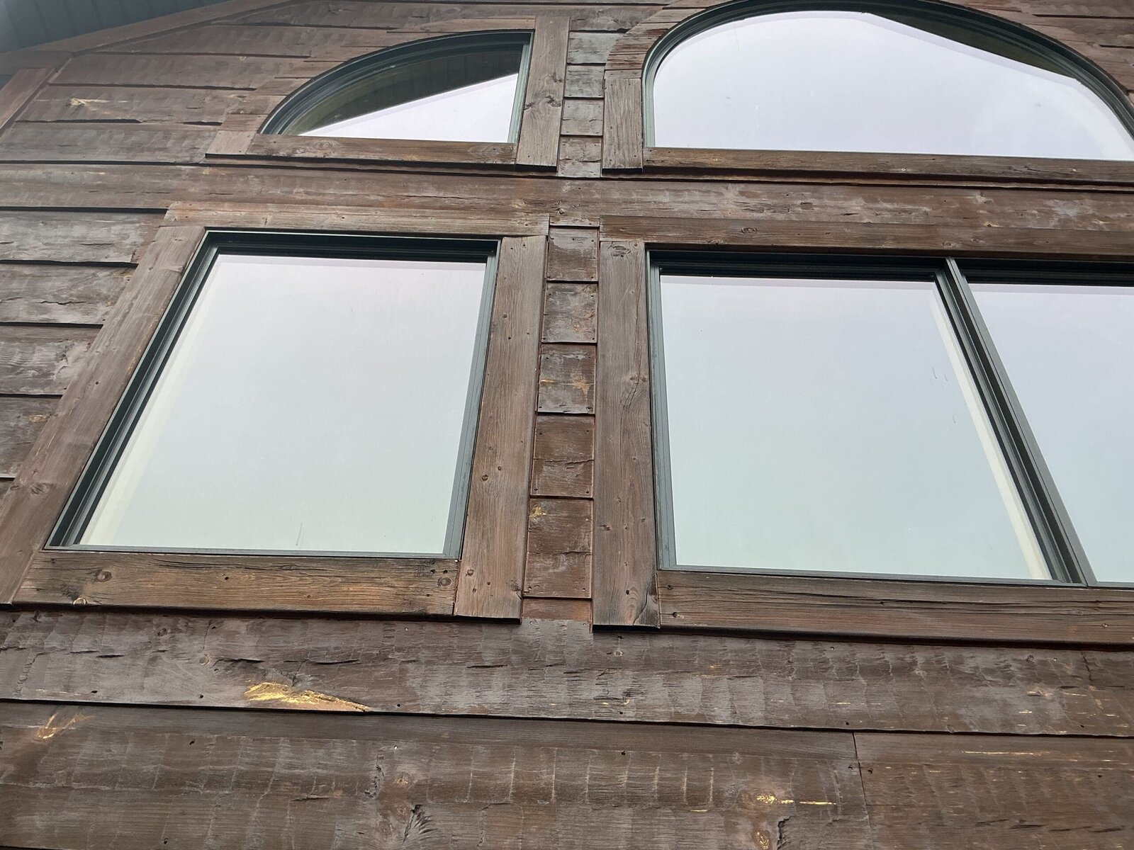 Weathered rough-sawn wood siding and window trim on an older East Tennessee home