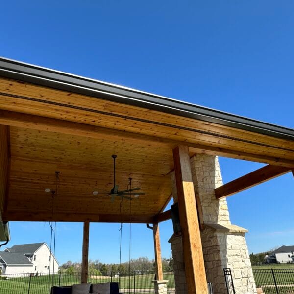 Covered porch with a tongue and groove wood ceiling, timber posts and stone columns in Knoxville, TN