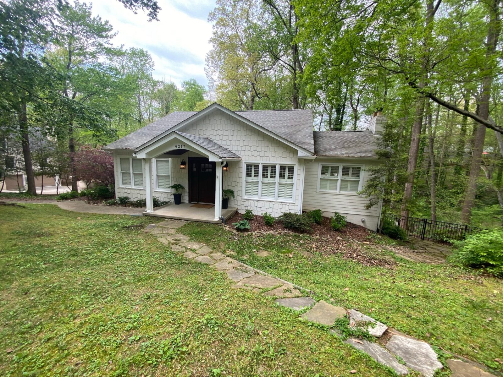 Completed home exterior with a shingle-pattern gable, lap siding and trim after an MI project in East Tennessee