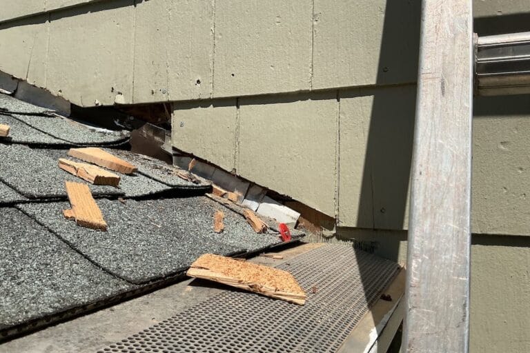 Roof-to-wall flashing failure behind siding on a Knoxville TN home