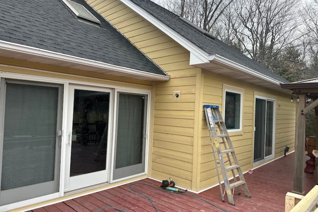 New James Hardie primed fiber cement siding around a covered porch on a Knoxville, TN home