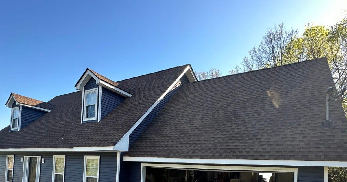 New brown architectural shingle roof with two dormers on a blue home in Knoxville, TN