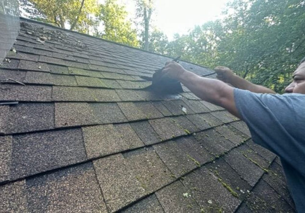 Roofing contractor inspecting shingles in Knoxville TN